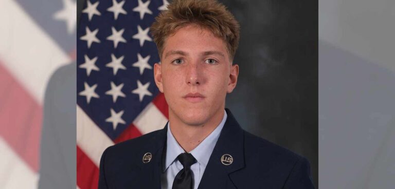 Airman 1st Class Garrett James in U.S. Air Force dress uniform, standing in front of an American flag.