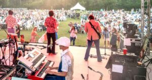 Band performing on stage at Concerts in the Village in Destin