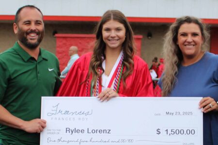 Rylee Lorenz receives the Roy Warner Memorial Scholarship from Frances Roy Agency representatives during a ceremony at Loudon High School.