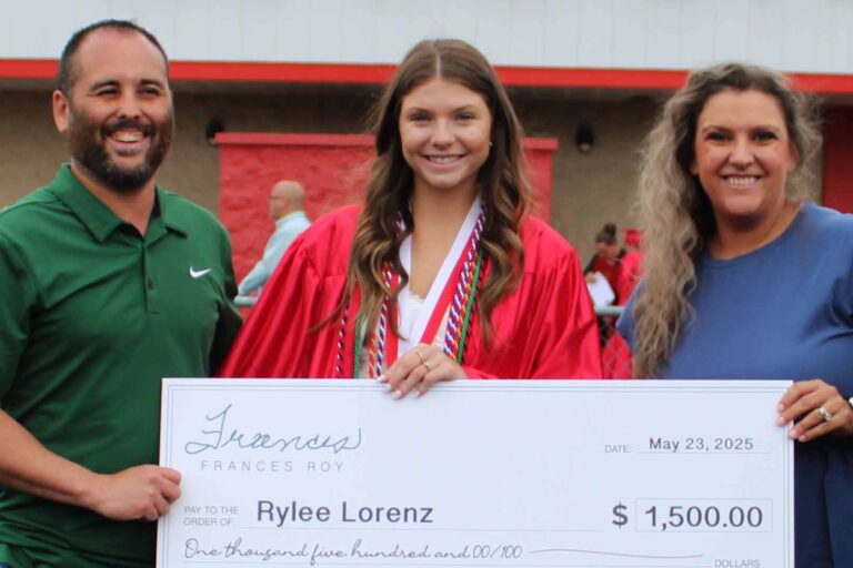 Rylee Lorenz receives the Roy Warner Memorial Scholarship from Frances Roy Agency representatives during a ceremony at Loudon High School.