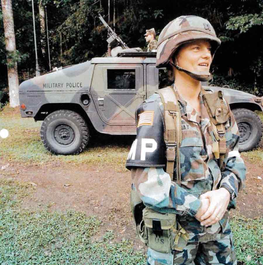 Captain Linda Bray in uniform in front of a military police Humvee