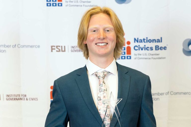 Noah Finkler holding his Florida State Civics Bee championship trophy