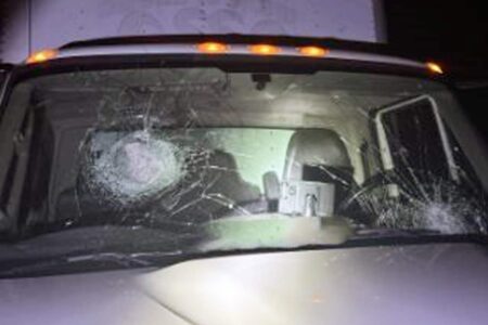Cracked windshield of a commercial vehicle struck by concrete on I-10