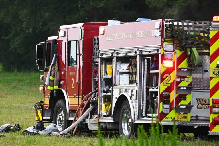Walton County Fire Rescue truck with hoses deployed on grassy field