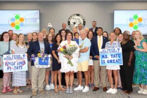 Brittany Tate stands with family, colleagues, and supporters after being named Assistant Principal of Pryor Middle School.