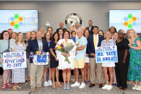 Brittany Tate stands with family, colleagues, and supporters after being named Assistant Principal of Pryor Middle School.