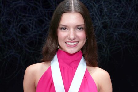 Niceville High School senior Avary Ritenour wearing a medal and pink dress.