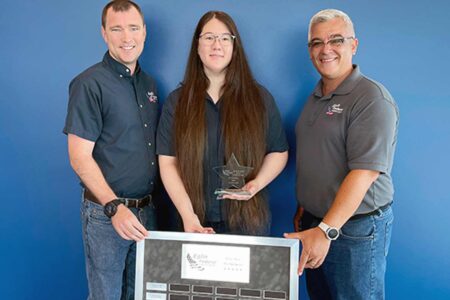 Elaine Carr holding award, standing with Eglin FCU colleagues