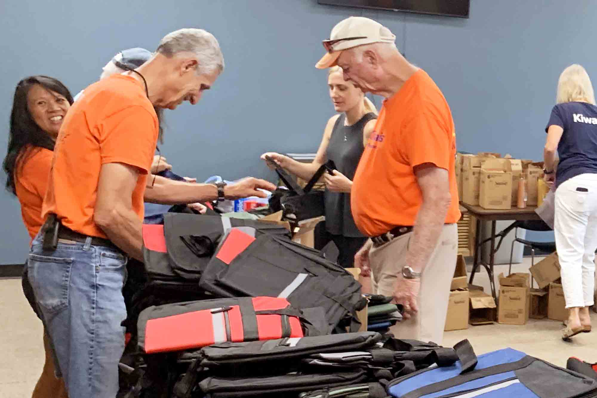 Volunteers pack duffel bags with essentials during the Bags of Hope event in Niceville.