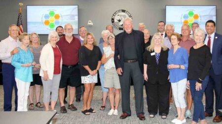 Family, colleagues, and community members gather with the Okaloosa County School Board to honor Dr. Ginny Morgan with the naming of Ruckel Middle School’s cafetorium.