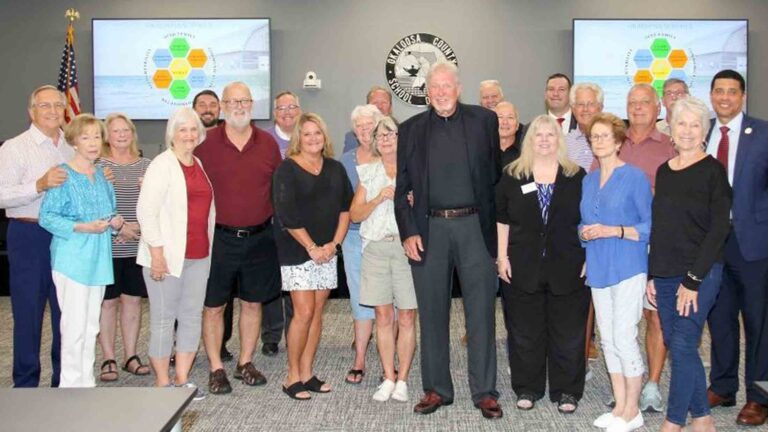 Family, colleagues, and community members gather with the Okaloosa County School Board to honor Dr. Ginny Morgan with the naming of Ruckel Middle School’s cafetorium.