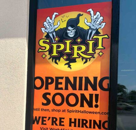 Cropped Spirit Halloween “Opening Soon” sign displayed on the window of the future Niceville store.