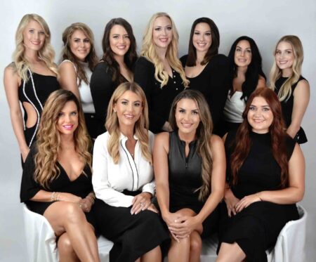 Aesthetic Artistry Medical Spa team members pose together in black and white attire.