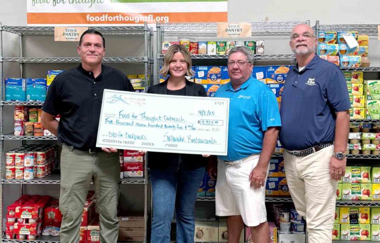 Saltwater Restaurants presents $5,725 check to Food For Thought Outreach from Bites for Backpacks campaign.