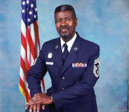 Retired CMSgt Les Chambers to lead Niceville Veterans Day Parade Retired U.S. Air Force Chief Master Sergeant Les Chambers poses in uniform beside the American flag.