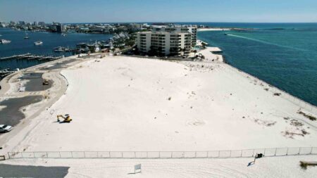 Aerial view of the newly acquired waterfront property in Destin beside existing condominiums.