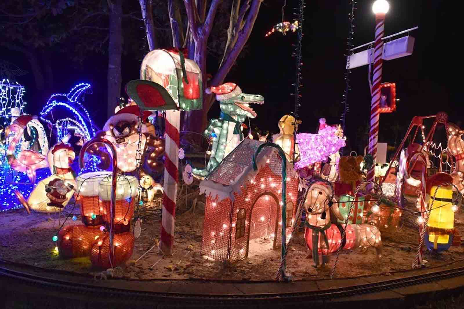 Christmas light display featuring colorful illuminated figures at Geek Lights on the Corner in Bluewater Bay, Florida.
