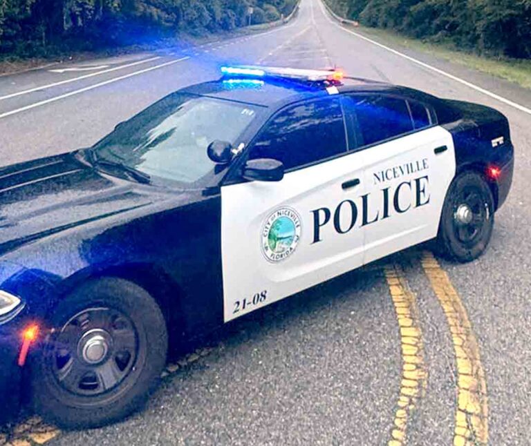 A Niceville Police Department patrol vehicle with emergency lights activated blocks a roadway.