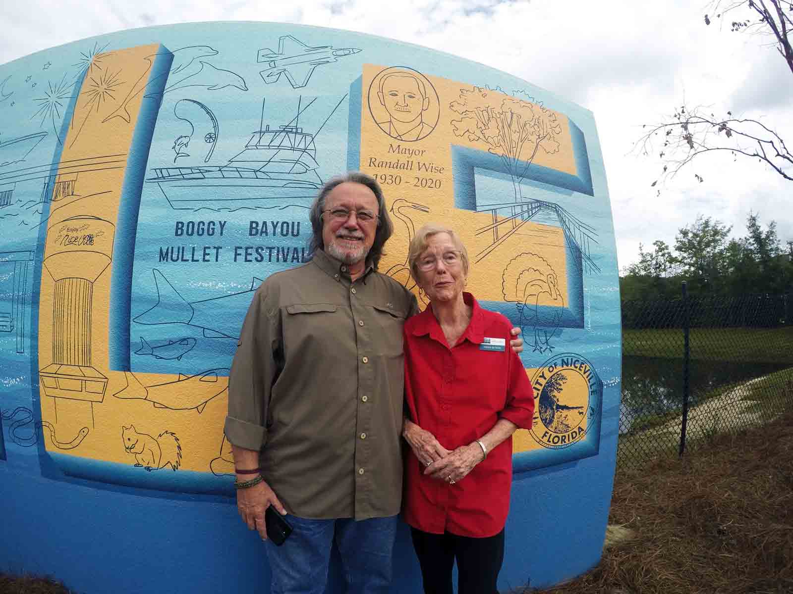 Randy Wise and Helen Wise stand beside the Niceville mural during the unveiling ceremony.