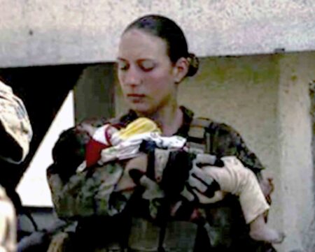 U.S. Marine Sgt. Nicole L. Gee holding an infant during the 2021 evacuation of Kabul.