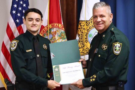 Deputy Jacob “Kyle” Behrens receives the Life Saving Award from Sheriff Eric Aden.