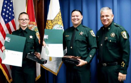 Deputies Makeena Ace-Moreno and Justin Spence receive Medal of Merit awards from the Okaloosa County Sheriff’s Office