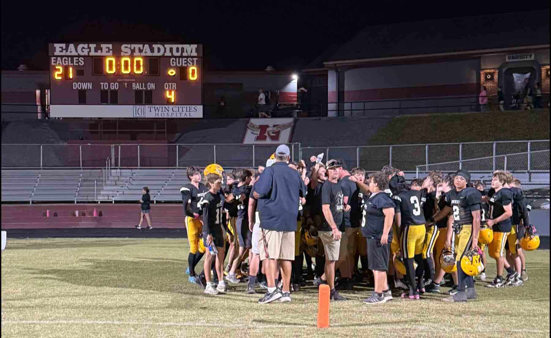 Ruckel Middle School Rams football team gathers on the field after a 21–0 playoff win at Eagle Stadium.