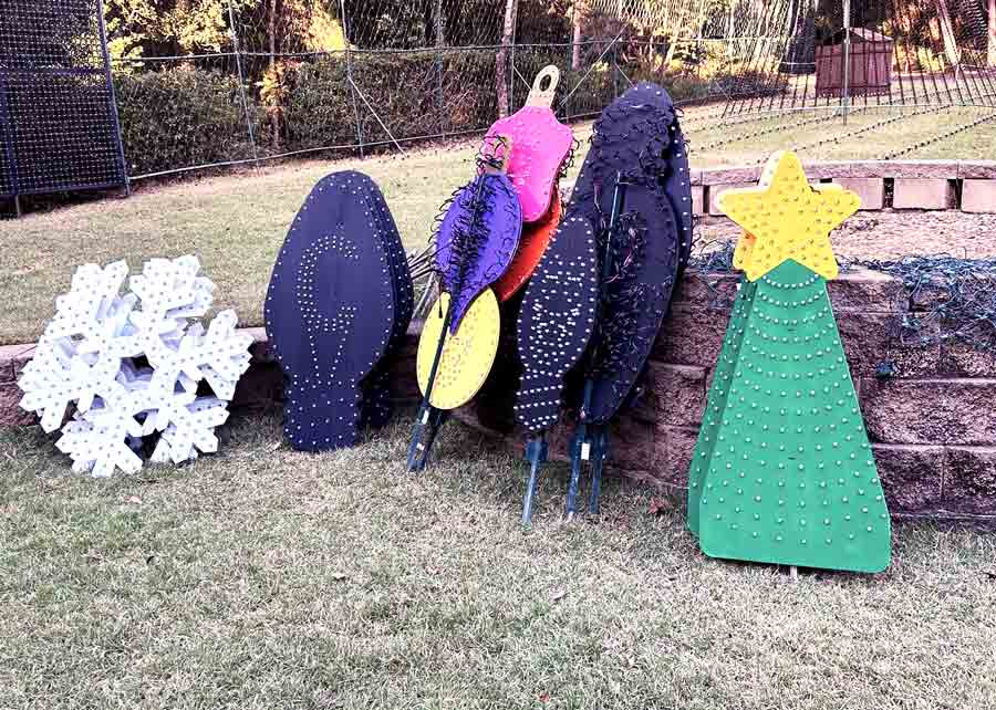 Christmas light panels shaped like bulbs, a snowflake, and a tree await installation for Geek Lights on the Corner in Bluewater Bay.