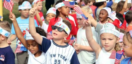 Okaloosa schools again earn Purple Star distinction Children wave small American flags during a school event supporting military families.