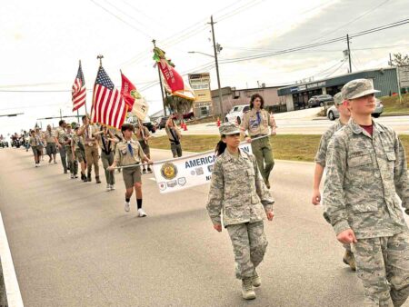 Local Scouts and cadets march down John Sims Parkway during the 2025 Veterans Day Parade in Niceville.