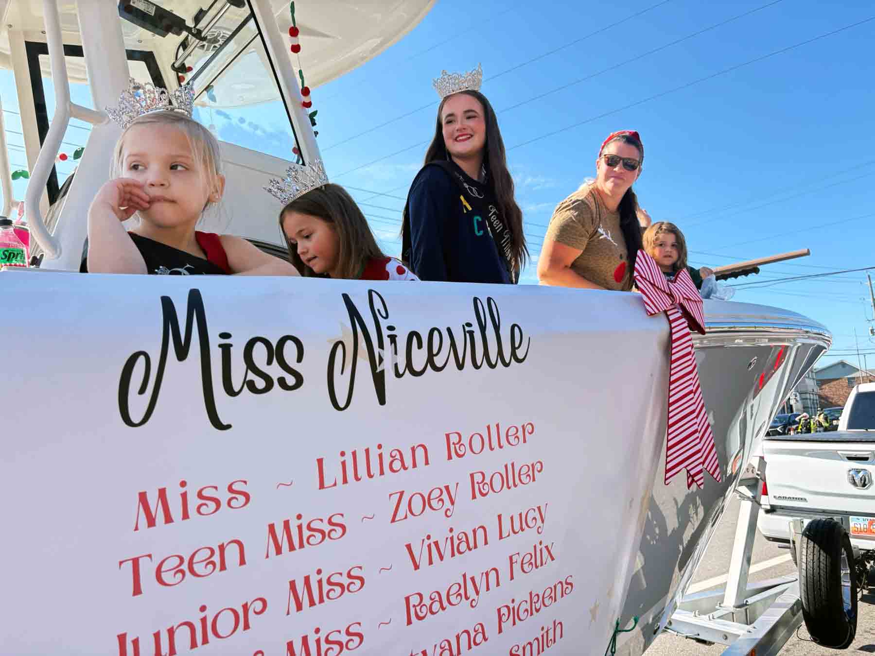 Miss Niceville titleholders ride on a parade float during the Niceville-Valparaiso Community Christmas Parade.