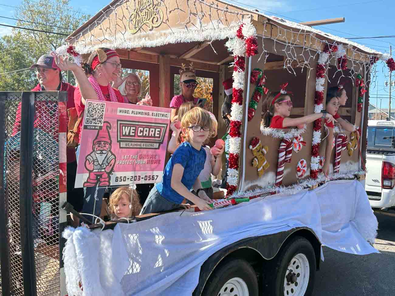 Children and adults ride on a gingerbread-themed float during the Niceville-Valparaiso Community Christmas Parade.