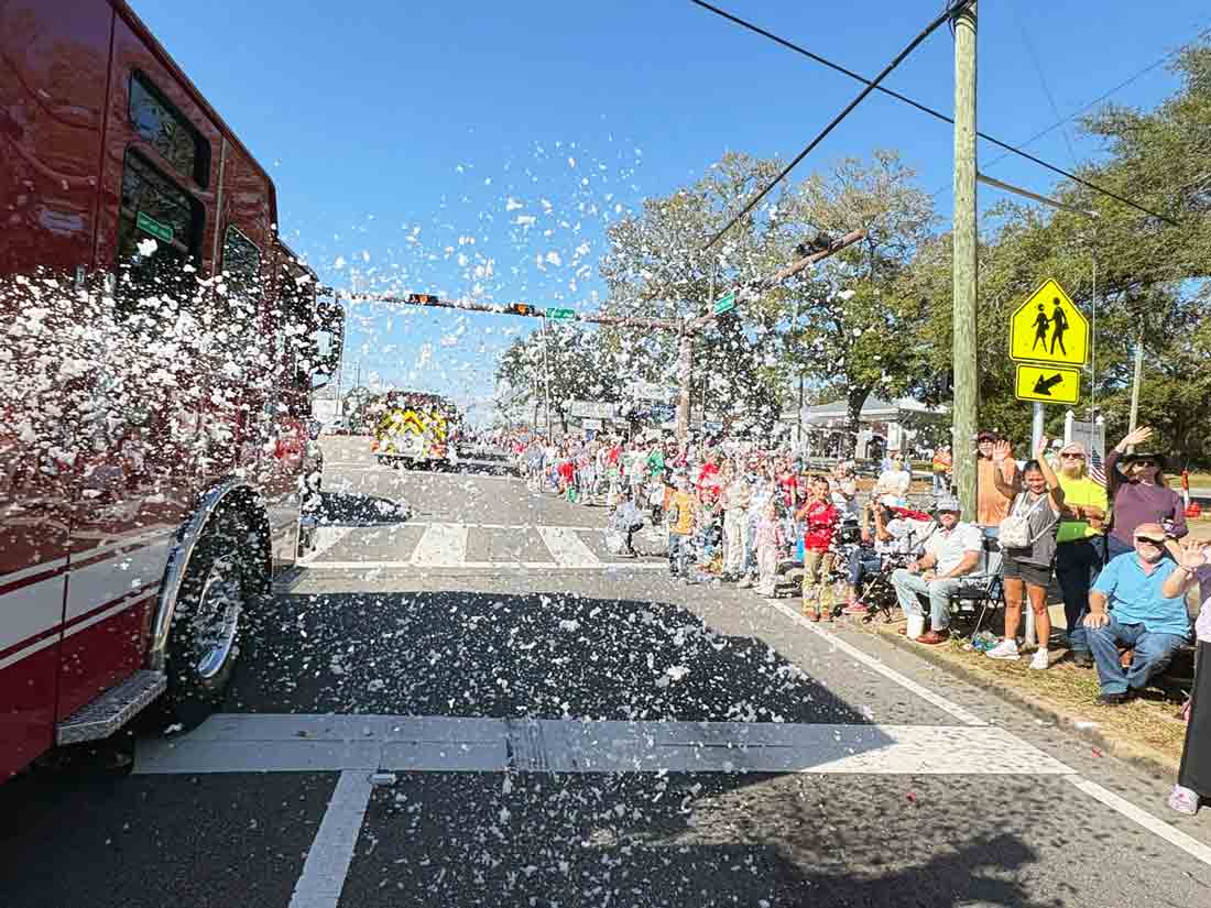 Children and adults ride on a gingerbread-themed float during the Niceville-Valparaiso Community Christmas Parade.