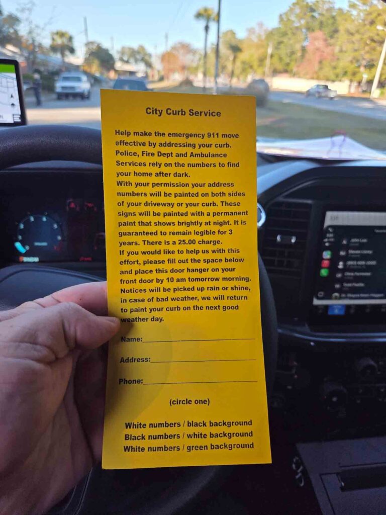Curb-painting solicitors prompt Niceville warning Yellow solicitation flyer for curb-painting services held inside a vehicle, showing service details and pricing.