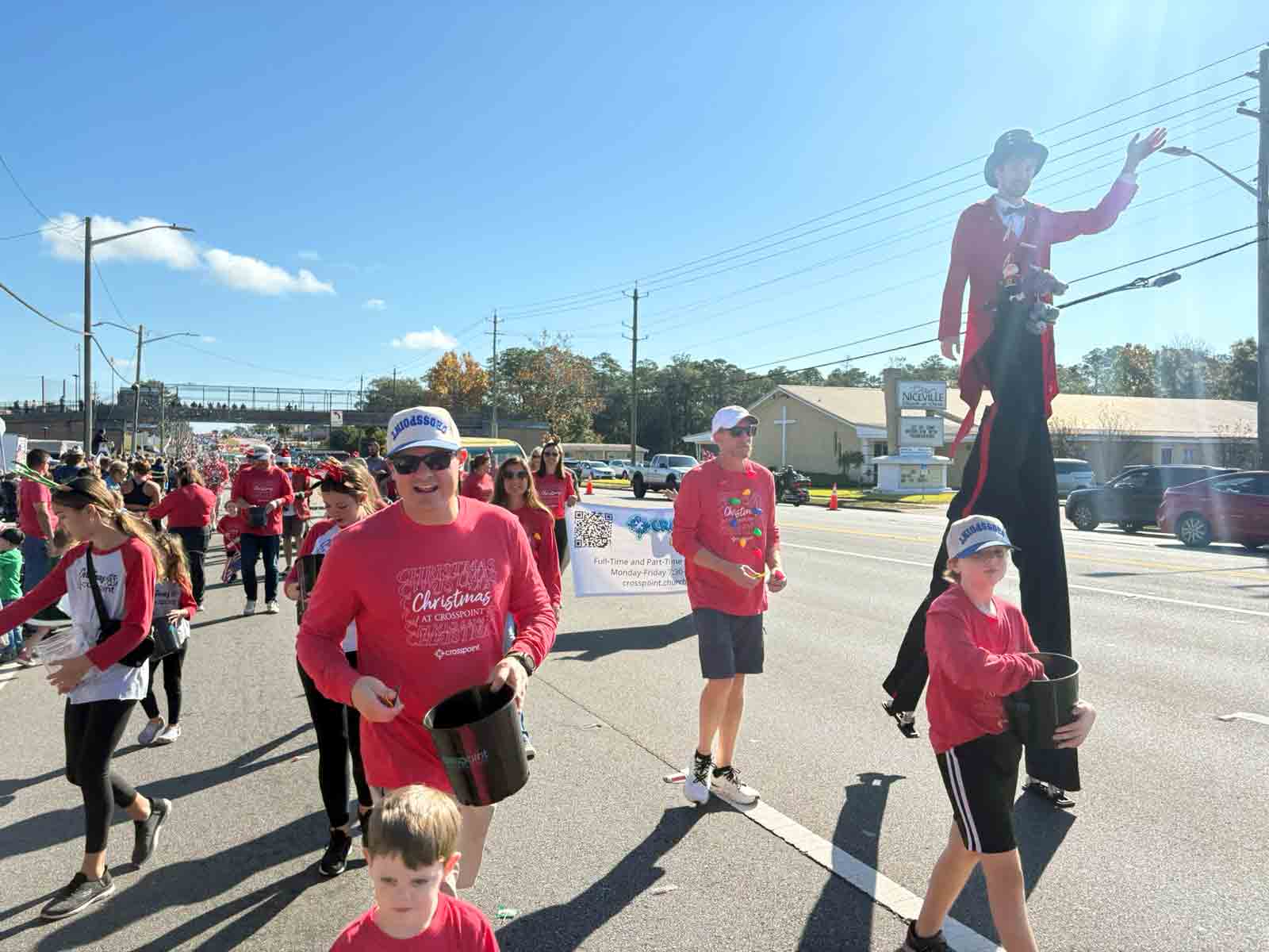 Parade participants from Crosspoint walk along John Sims Parkway during the Niceville Christmas Parade.