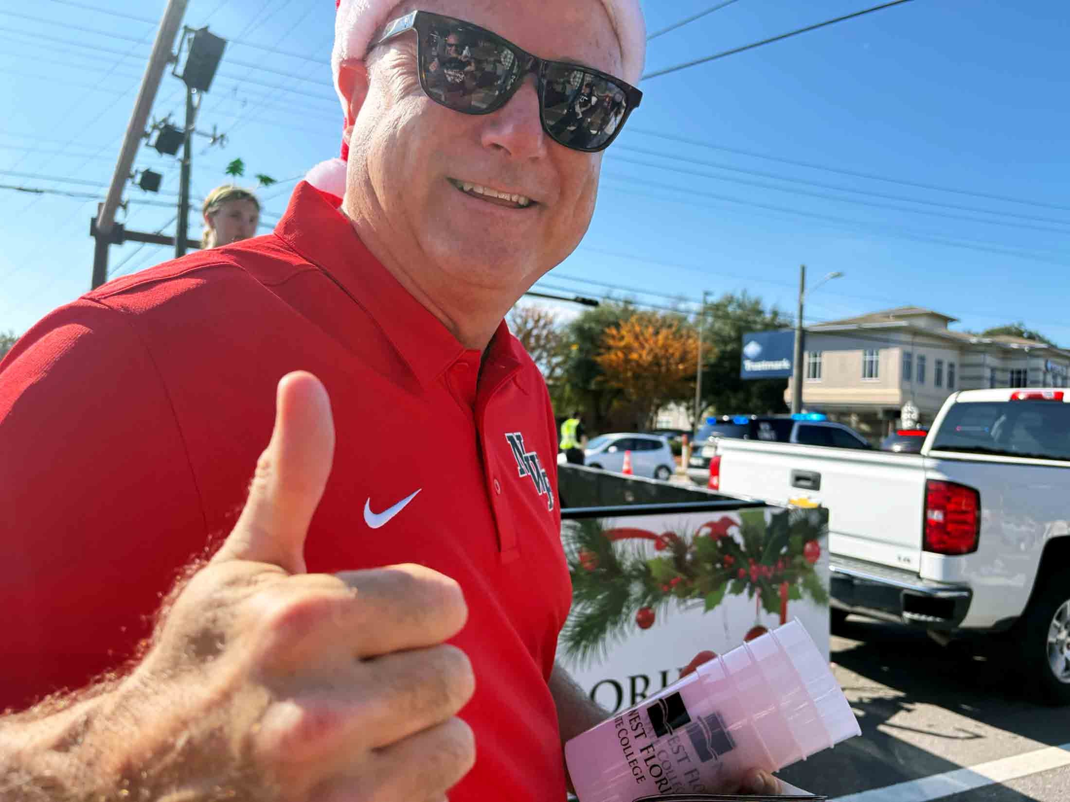 Northwest Florida State College President Mel Ponder gives a thumbs-up while attending the Niceville Christmas Parade.