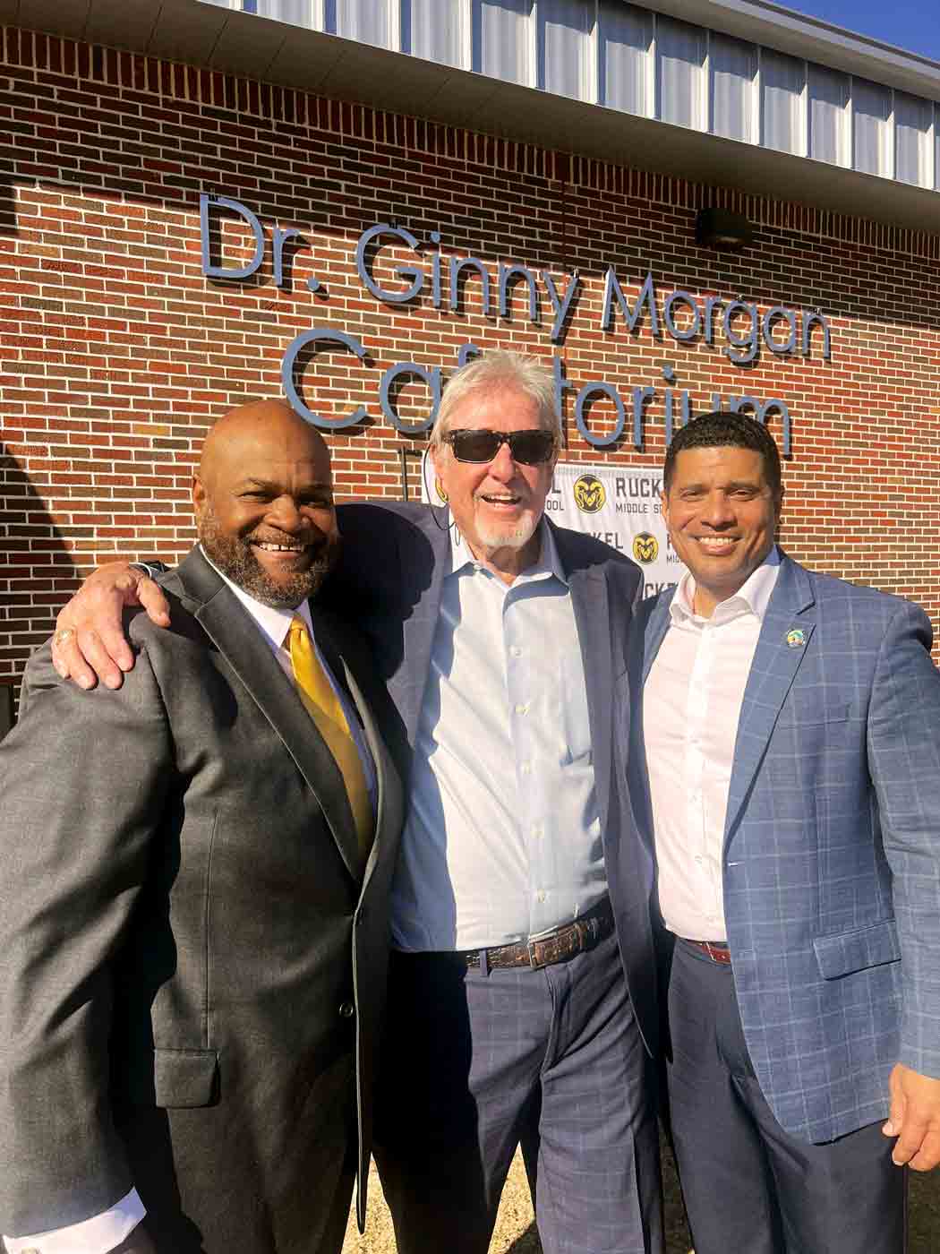 School leaders and family members stand outside the Dr Ginny Morgan Cafetorium at Ruckel Middle School