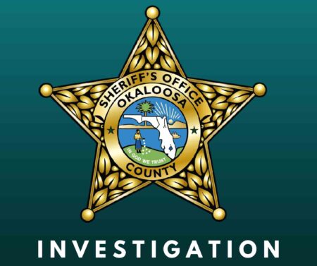 Okaloosa County Sheriff’s Office badge displayed on a green background with the word “Investigation” beneath it.