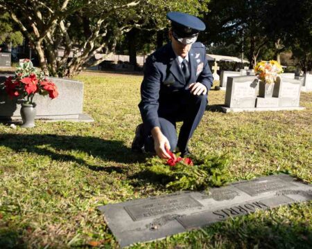 U.S. Air Force Col. Brian Taylor places a wreath at Beale Memorial Cemetery during the 2025 Wreaths Across America ceremony.