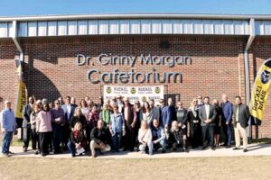 Ruckel Middle honors former principal with cafetorium dedication Group gathered outside Ruckel Middle School beneath the Dr Ginny Morgan Cafetorium sign