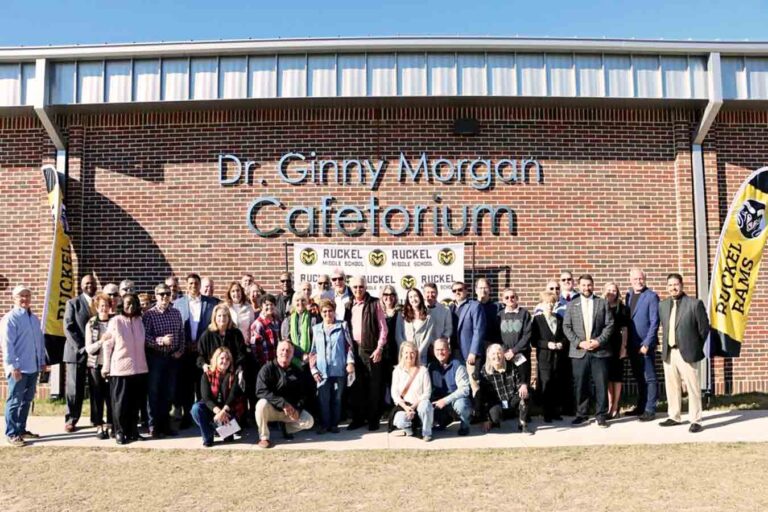 Ruckel Middle honors former principal with cafetorium dedication Group gathered outside Ruckel Middle School beneath the Dr Ginny Morgan Cafetorium sign