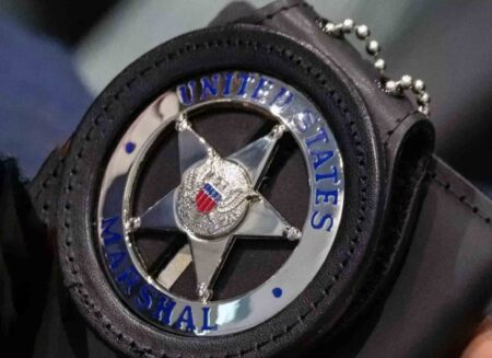 U.S. Marshals Service badge in black leather badge holder