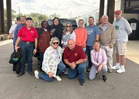 Volunteers pose for a group photo during a food distribution event in Niceville.