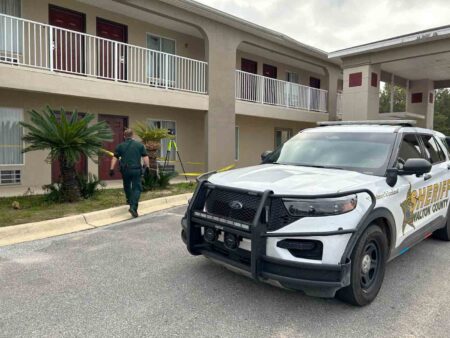 Walton County Sheriff’s Office deputy outside hotel during incident in DeFuniak Springs.