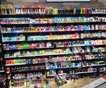 Shelves display a wide variety of vaping devices and vape-related products inside a retail store.