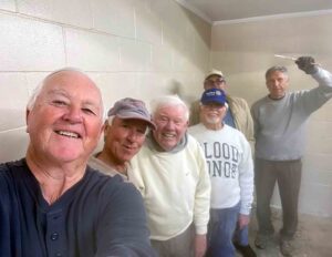 Mid-Bay Bridge Rotary Club volunteers pose inside Turkey Creek Park restrooms during renovation painting work in Niceville.