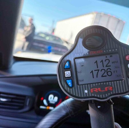 Law enforcement lidar device displaying 112 mph speed reading during traffic stop