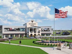 Artist rendering of the planned Air Commando Museum at Hurlburt Field Memorial Air Park with visitors, aircraft displays, and an American flag.