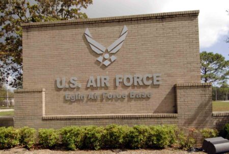 U.S. Air Force Eglin Air Force Base entrance sign mounted on a brick wall with the Air Force symbol above the lettering