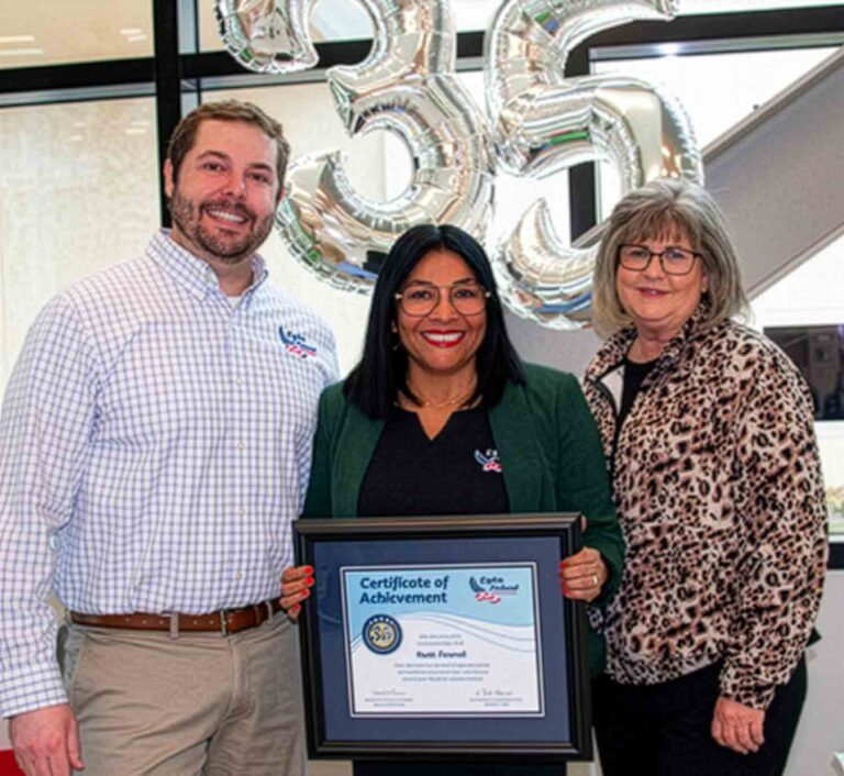 SVP Branch Operations Bron Ringstad, AVP Contact Center Operations Ruth Fennell, and SVP/Chief Operations Officer Kim Nauta stand together as Fennell holds a Certificate of Achievement recognizing 35 years of service, with silver “35” balloons displayed behind them.